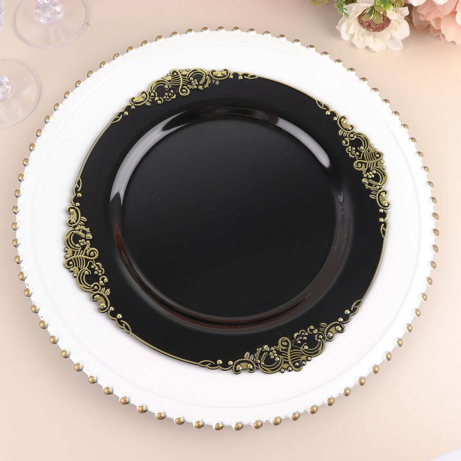 Elegant black plate with gold ornate design on a white charger.