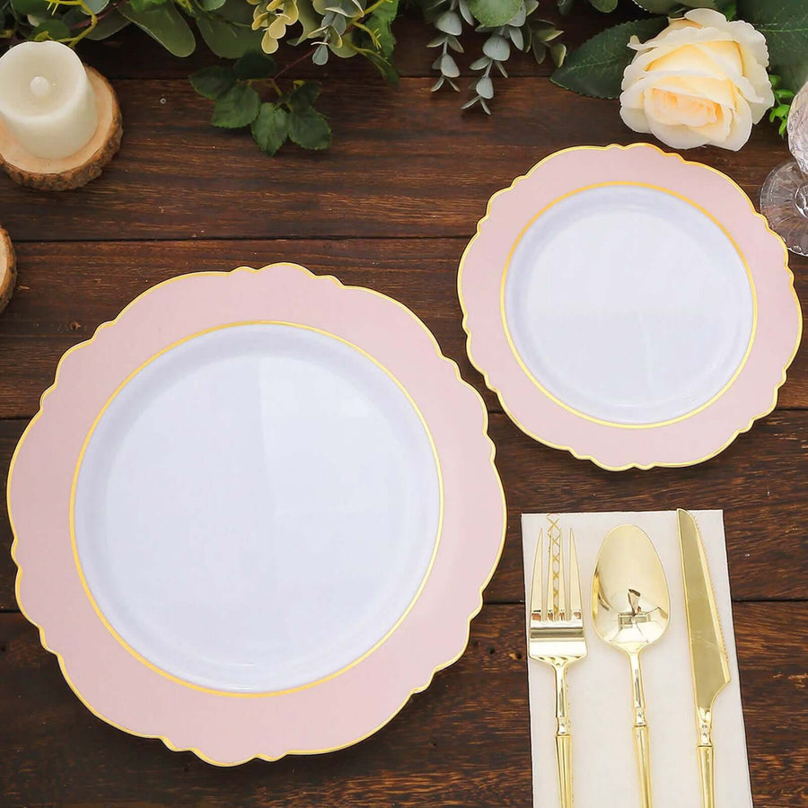 Elegant pink and gold rimmed plates with cutlery on a wooden table.