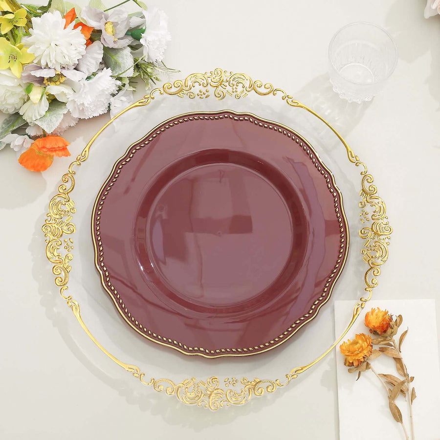 Elegant maroon plate with gold trim on decorative clear charger.