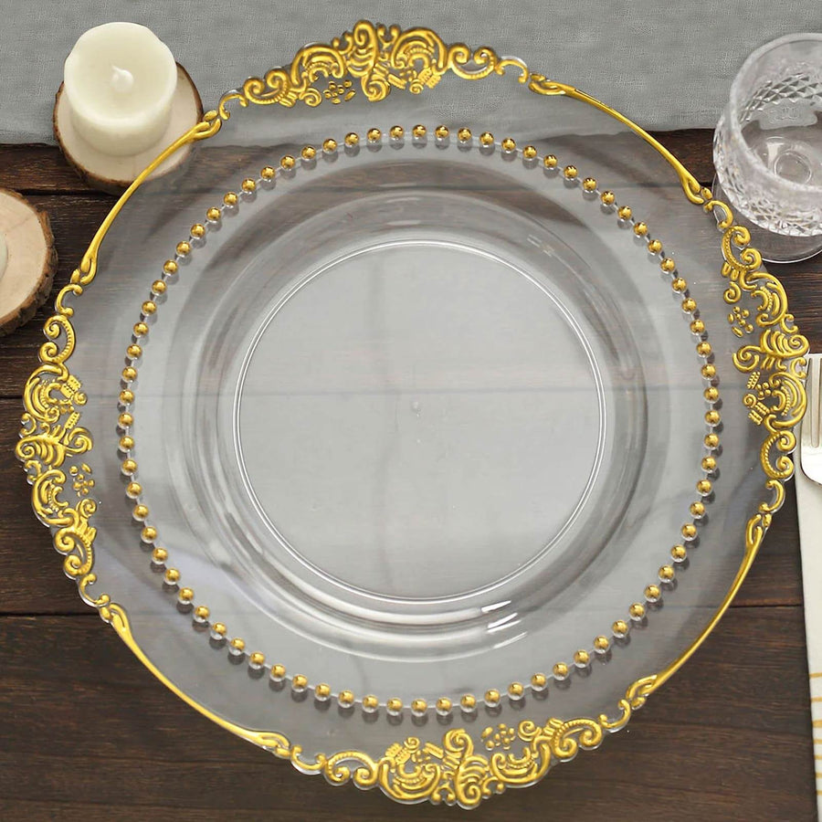 Elegant clear glass plate with gold embellishments and beaded rim.