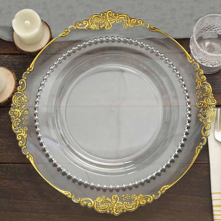 Elegant clear plate with gold and silver accents on dark wood table.