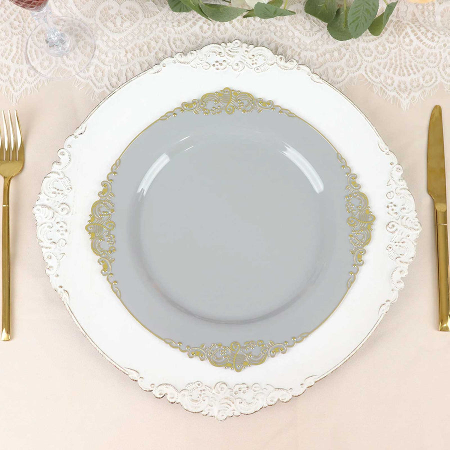 Elegant gray plate with gold detailing on decorative white charger.