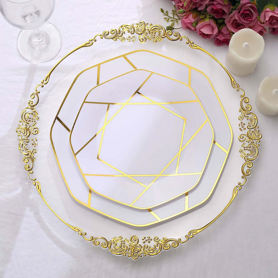Elegant gold decorative plates set on a white table with flowers and candles.
