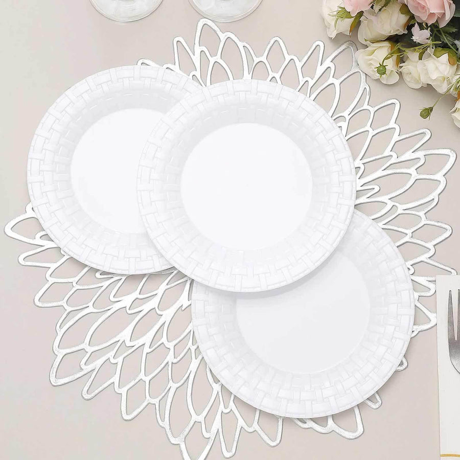 Three white decorative plates on a lace-style table mat.
