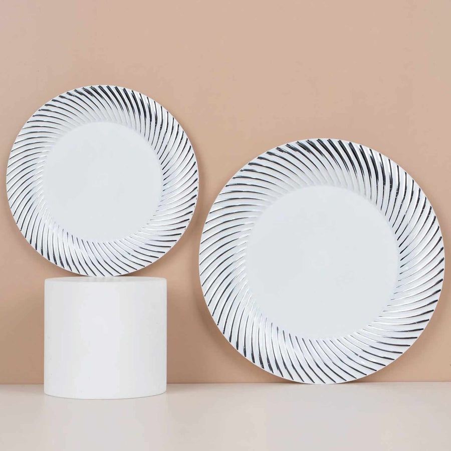 Two decorative plates with a spiral pattern, displayed on a minimal pedestal.