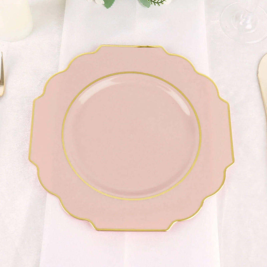 Pink decorative plate with gold rim on a table setting.