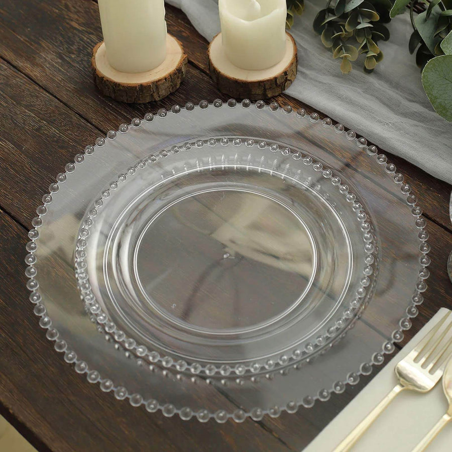 Clear decorative plate with beaded rim on rustic wooden table.