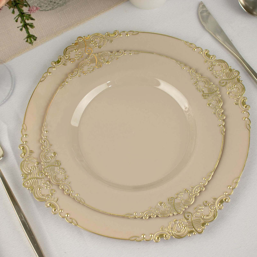 Elegant cream plates with intricate gold detailing on a table setting.