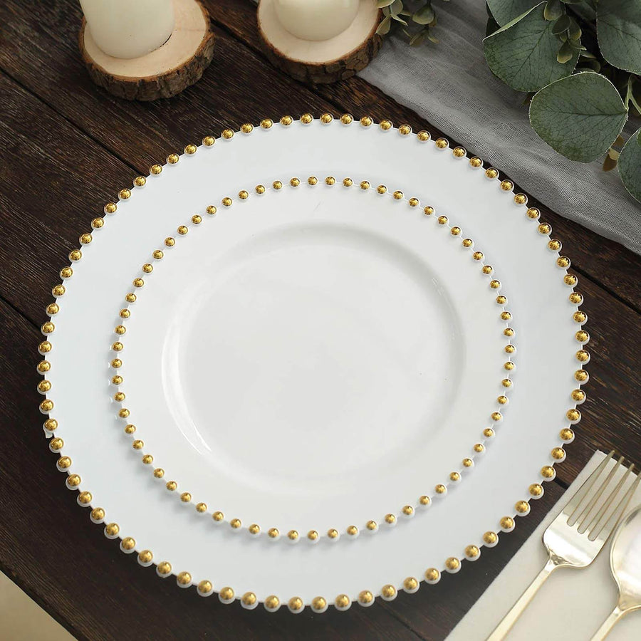 Elegant white plate with gold beaded rim on a rustic wooden table.