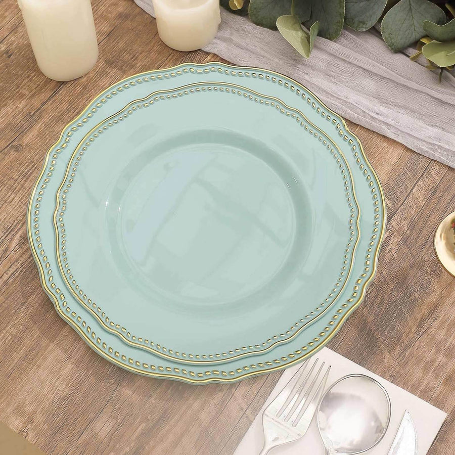 Elegant turquoise plate with gold trim on a wooden table setting.