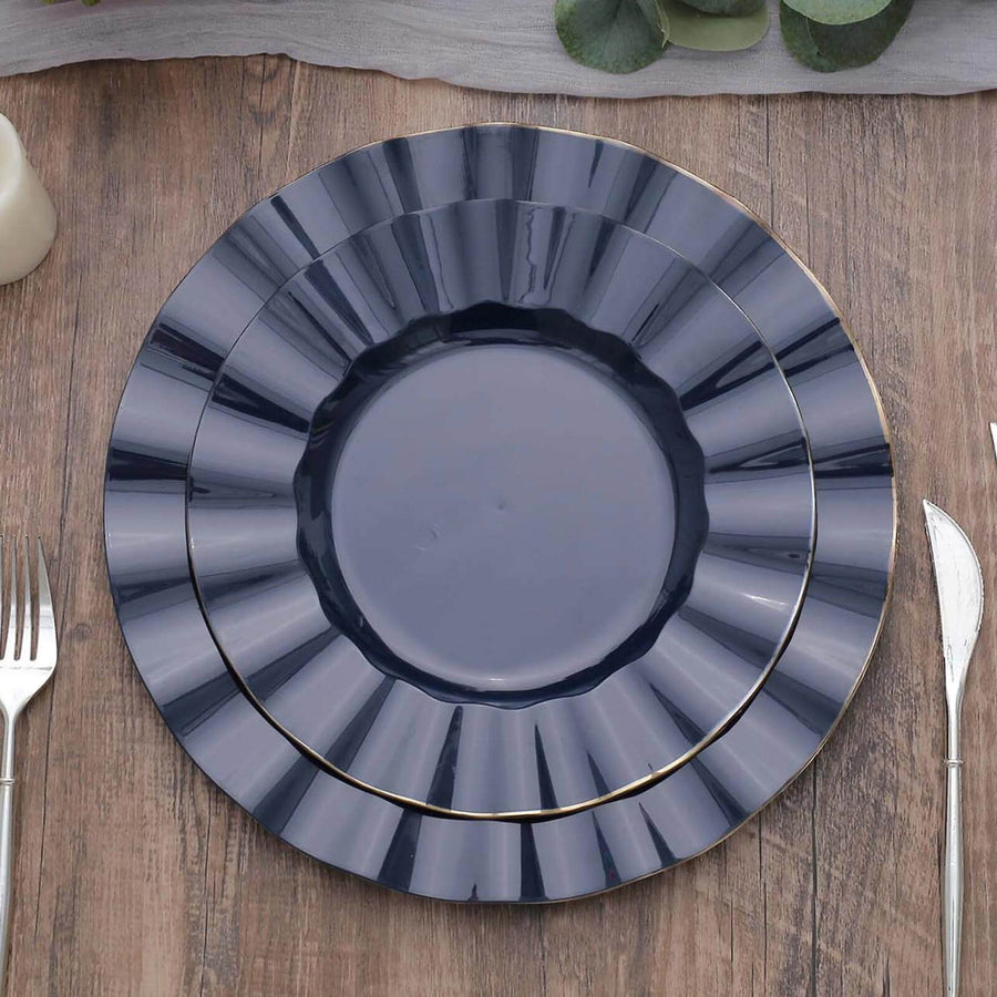 Elegant navy blue dinner plates with gold trim, arranged on a wooden table.