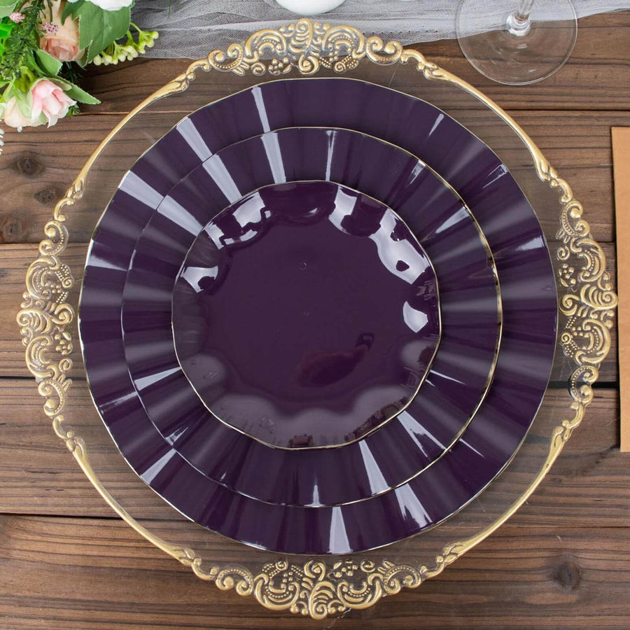 Elegant purple plates with gold accents stacked on a rustic wooden surface.