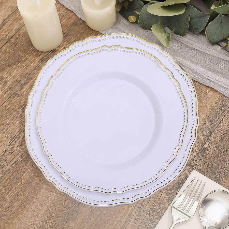 Elegant white plate with gold trim on a rustic wooden table setting.