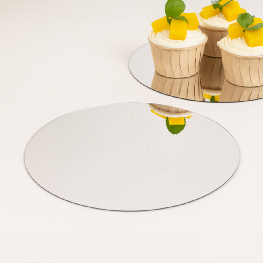 Round mirror cake board with reflections, ideal for dessert presentations.
