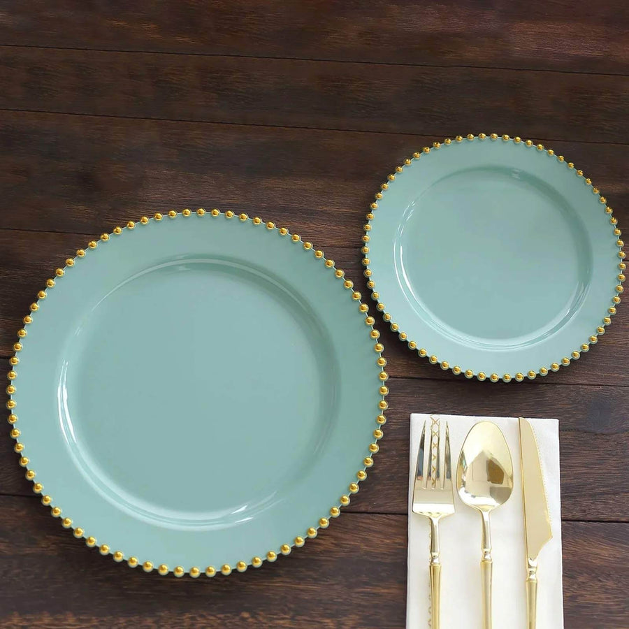 Mint green plates with gold bead trim, styled with cutlery on wooden table.