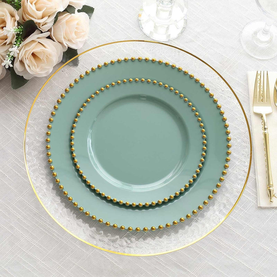Elegant stacked plates with gold bead accents and a clear charger.