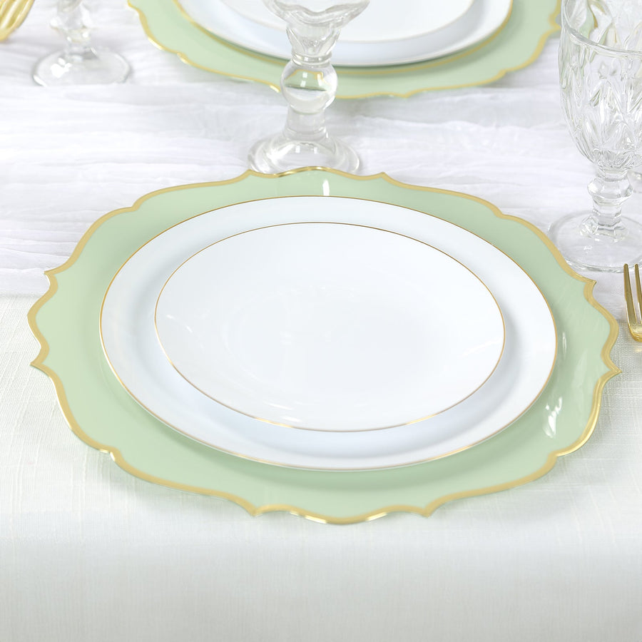 Elegant green and white dinner plate set with gold trim on a table setting.
