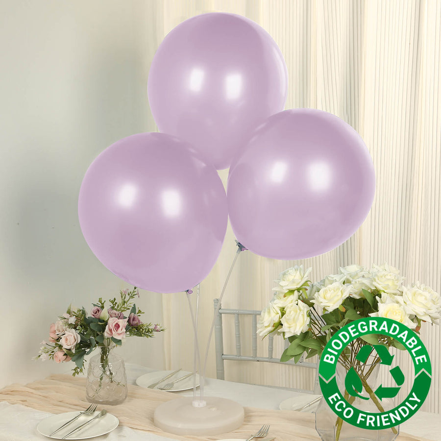 Lavender biodegradable balloons on a table with flowers.