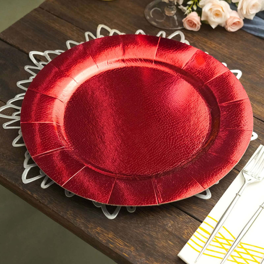 Red decorative plate on a wooden table setting with floral accents.