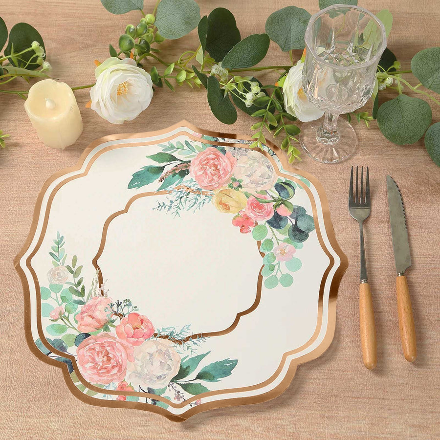 Floral decorative plate with gold trim on a rustic table setting.