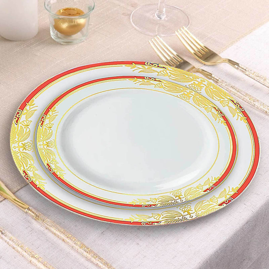 Elegant white plates with gold and red decorative borders on a table setting.