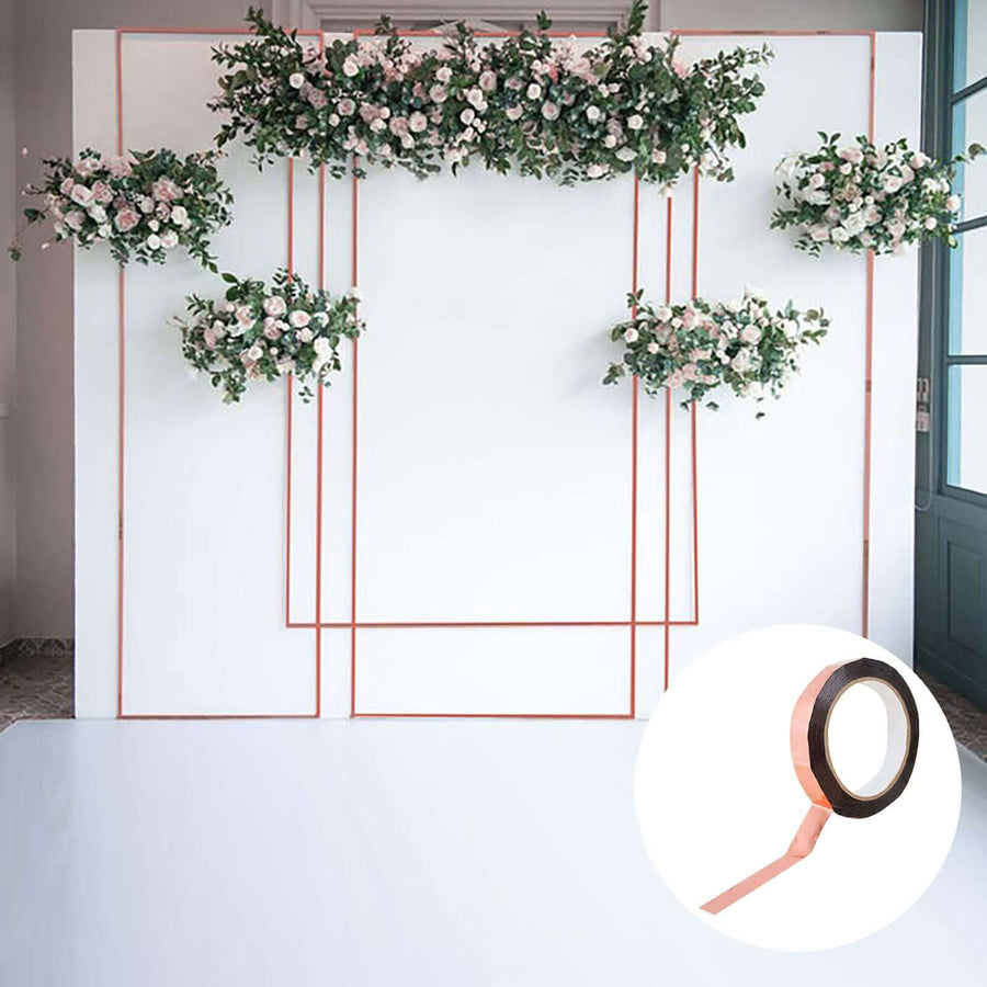 Rose gold floral backdrop with hanging arrangements for events.