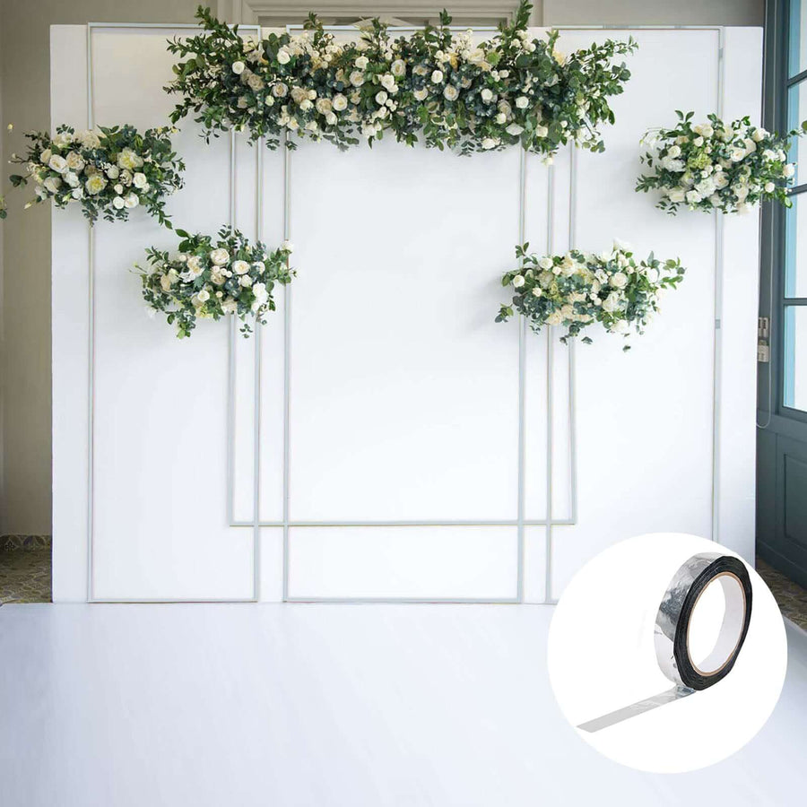 Clear adhesive tape roll on a white backdrop with floral decorations.