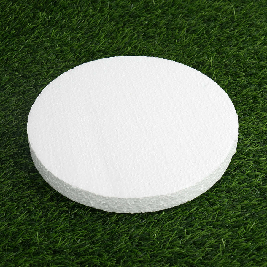 White round foam disc on grass surface.