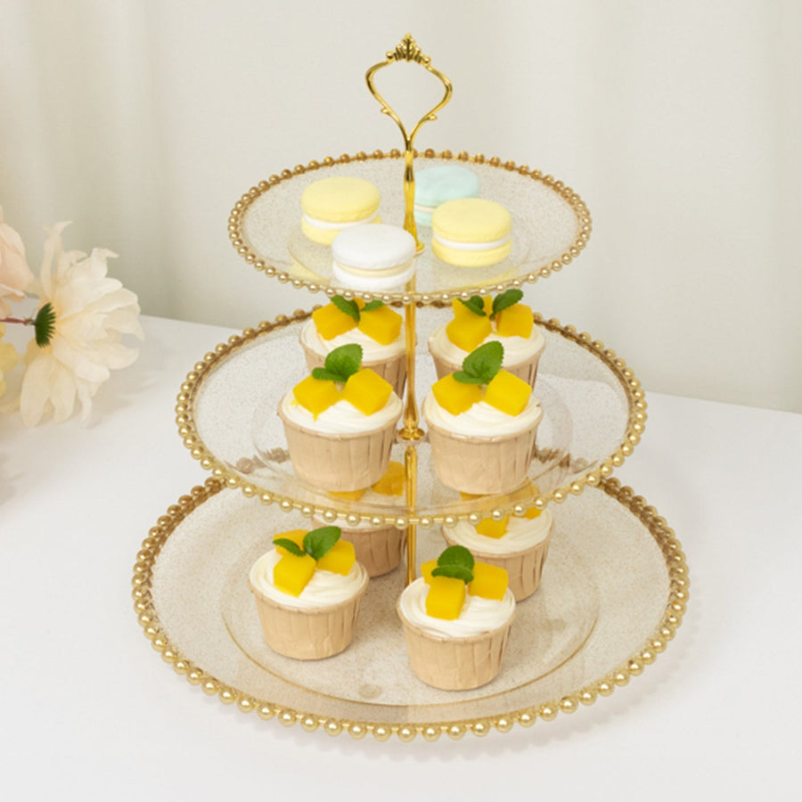Three-tiered dessert stand with cupcakes and macarons, elegantly displayed.
