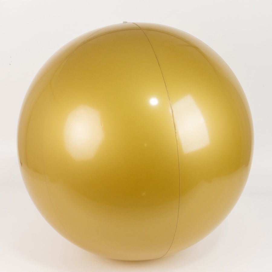 Gold beach ball on a plain white background.