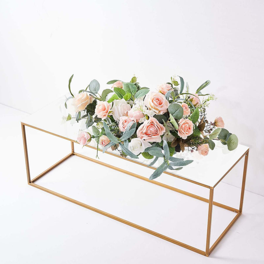 Coffee table with artificial flowers and greenery arrangement.