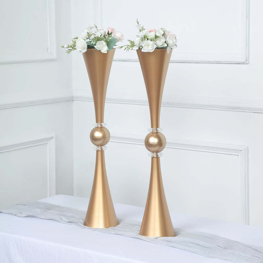 Elegant gold vases with floral arrangements, perfect for home decor.