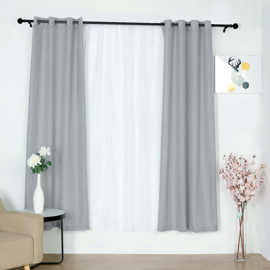 Gray curtains hanging in a modern living room with decorative elements.