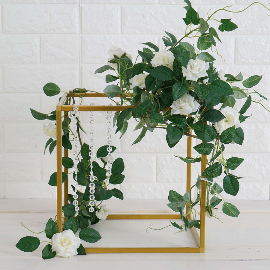 Decorative gold frame with white roses and greenery accents.