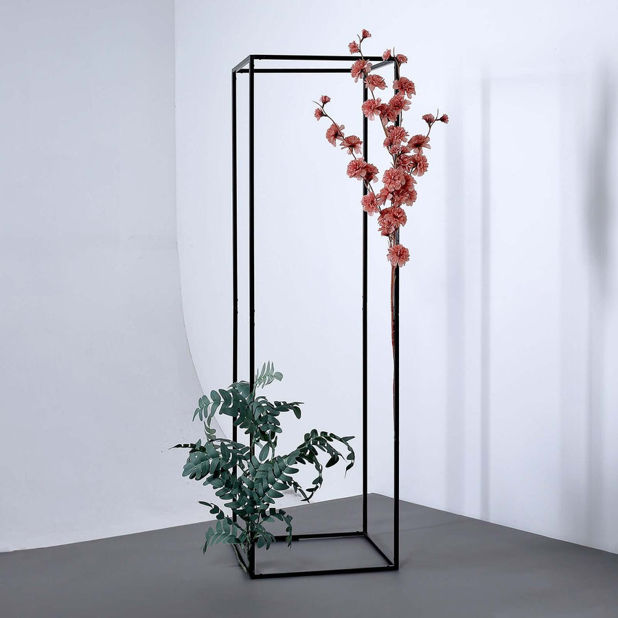 Black metal display stand with pink flowers and green leaves.