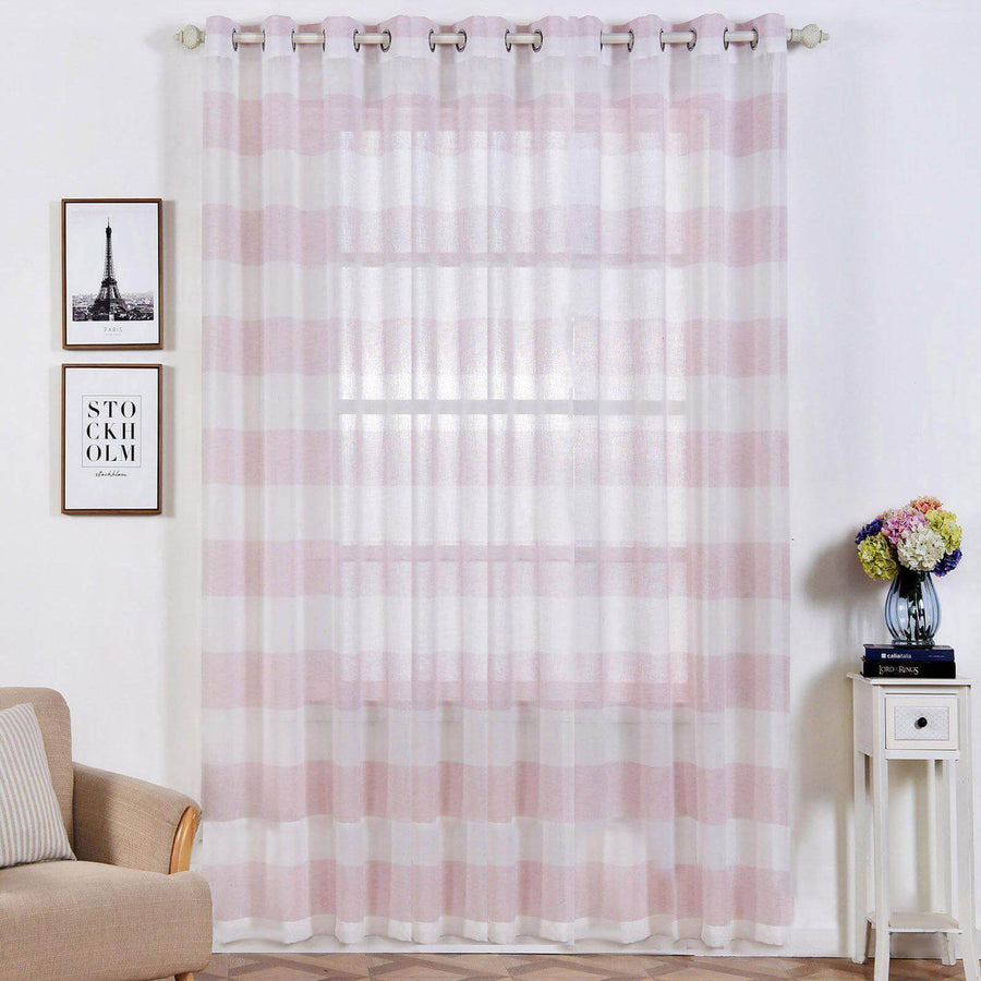Sheer pink striped curtains hanging in a stylish living room setting.