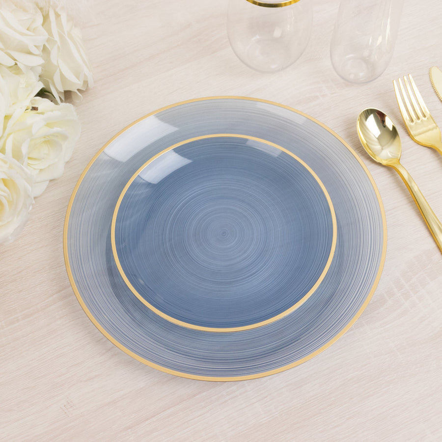 Elegant blue decorative plate with gold rim on a light wood table.