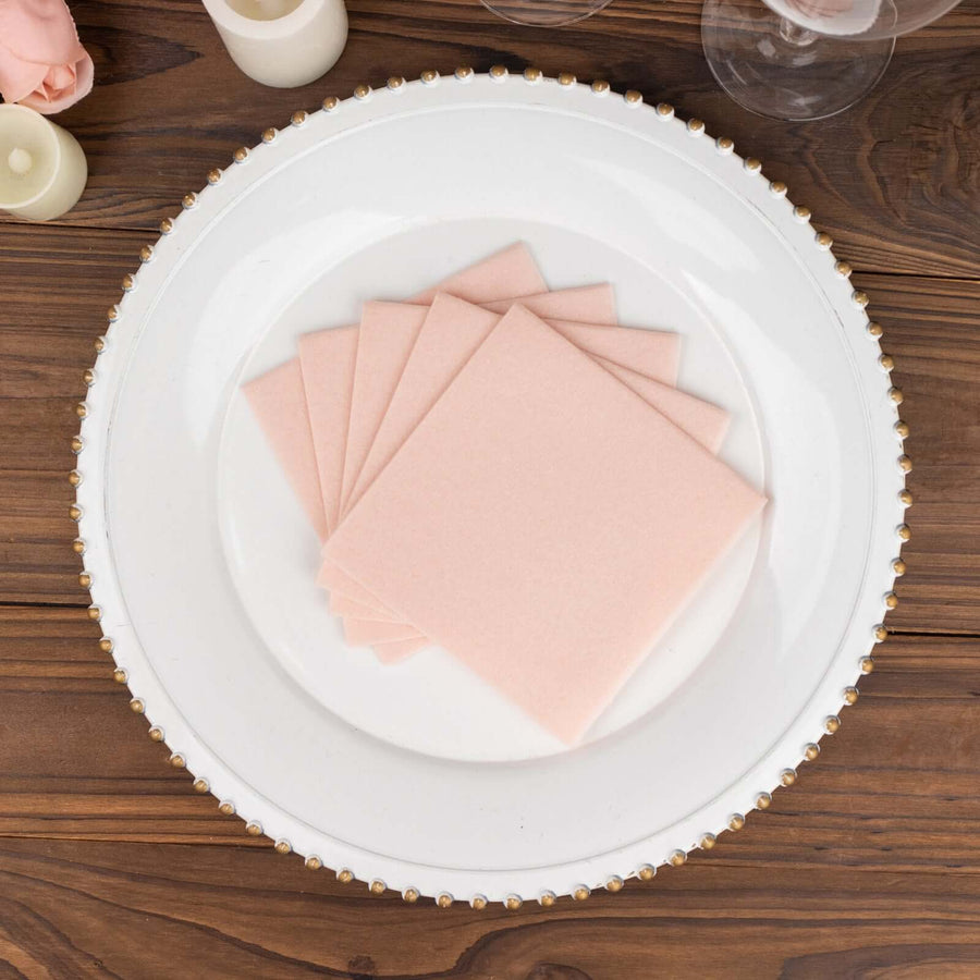 Pink square coasters arranged on a decorative plate.