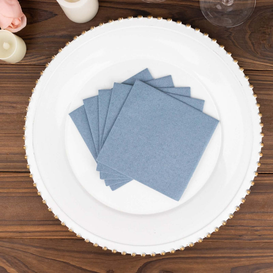 Blue fabric coasters neatly arranged on a decorative white plate.