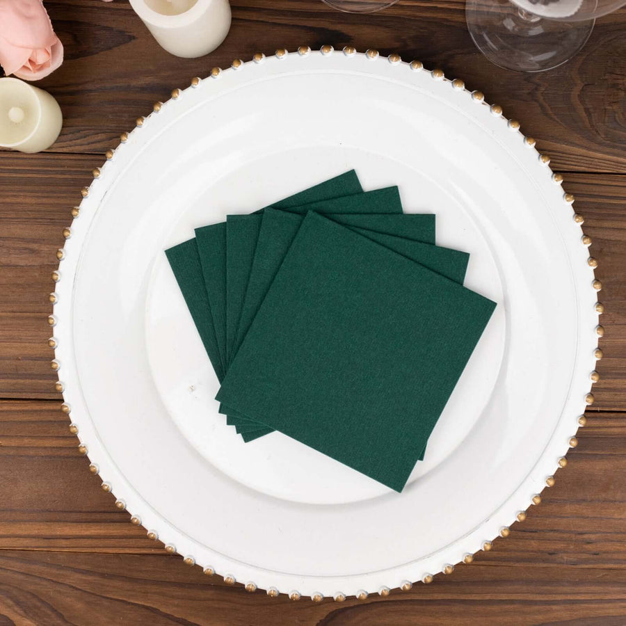 Green square paper coasters on a decorative plate.