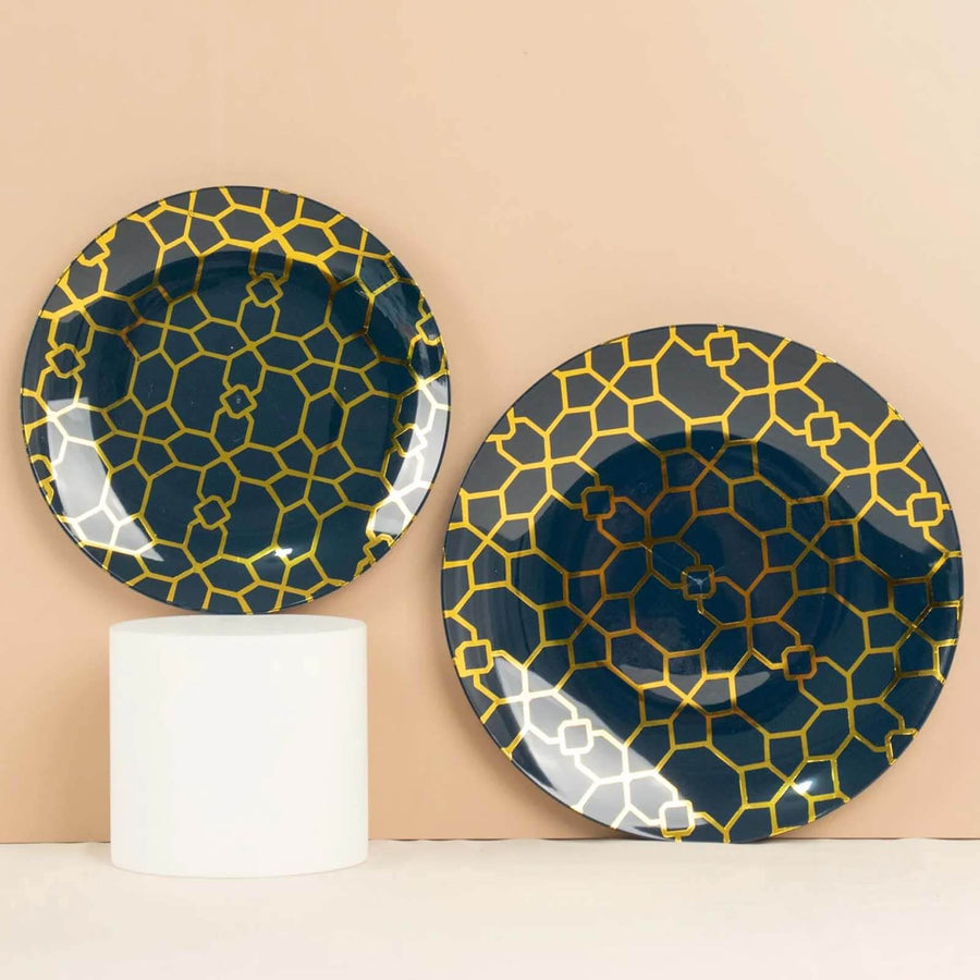 Decorative plates with geometric patterns in navy and gold against a neutral background.