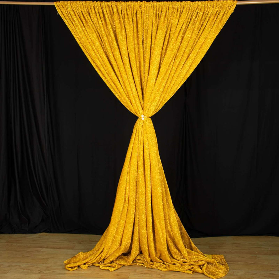 Shimmering yellow curtain draped elegantly against a dark backdrop.