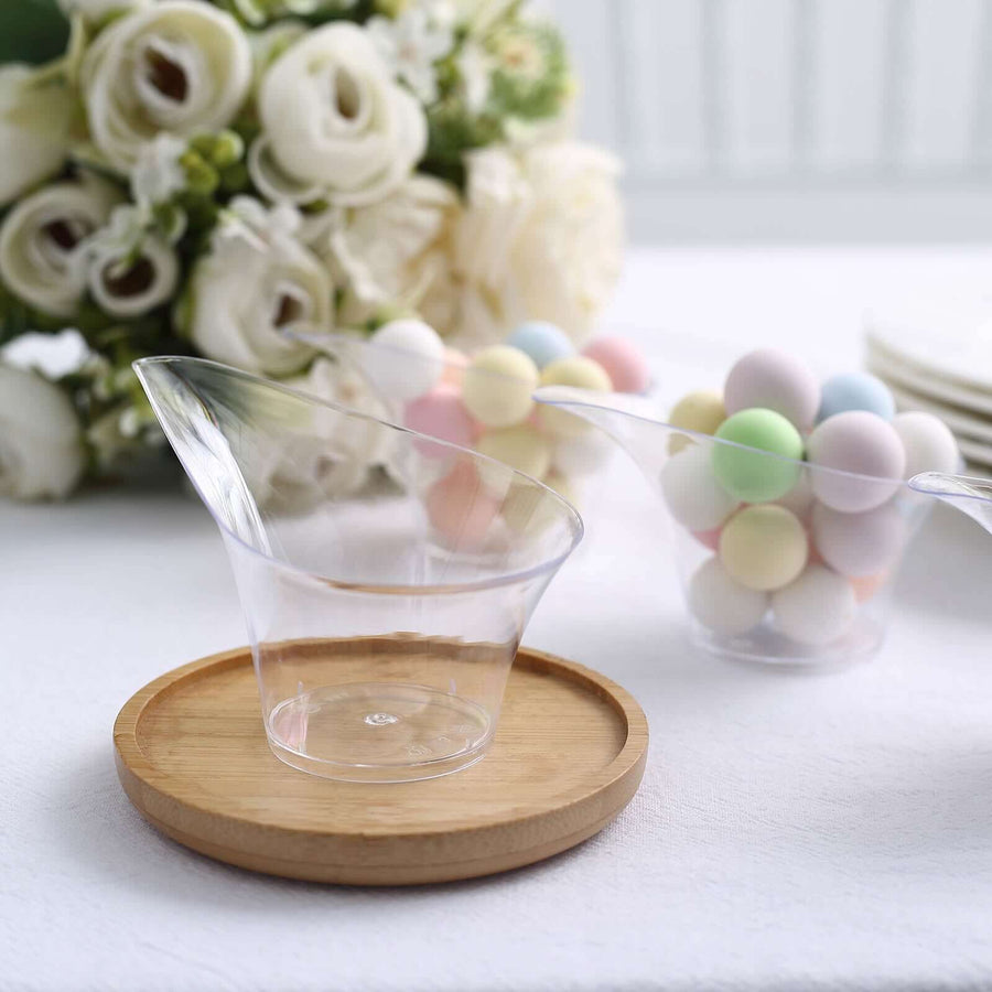 Clear dessert cups on a wooden tray with colorful candy and flowers in the background.