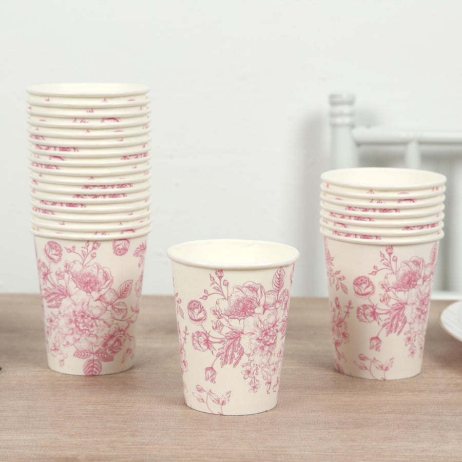 Floral printed paper cups stacked on a wooden table.