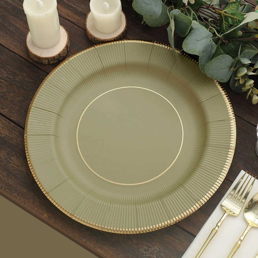 Elegant olive green charger plate with gold rim on wooden table.