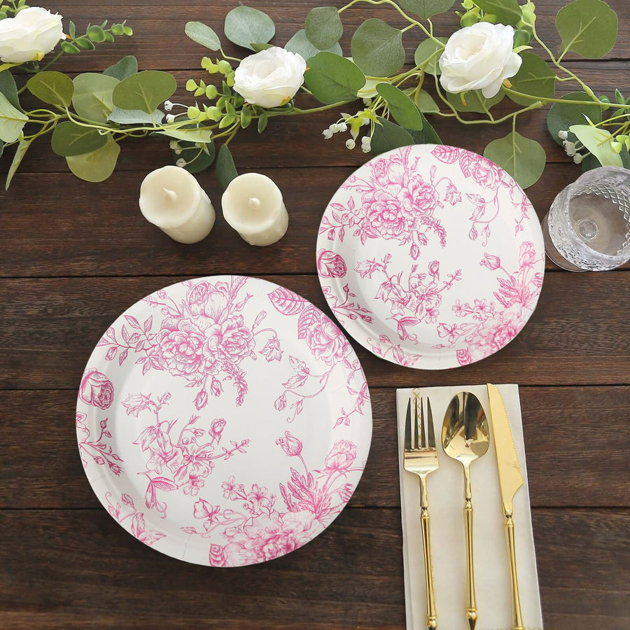 Elegant floral dinner plates with gold utensils on a rustic table setting.