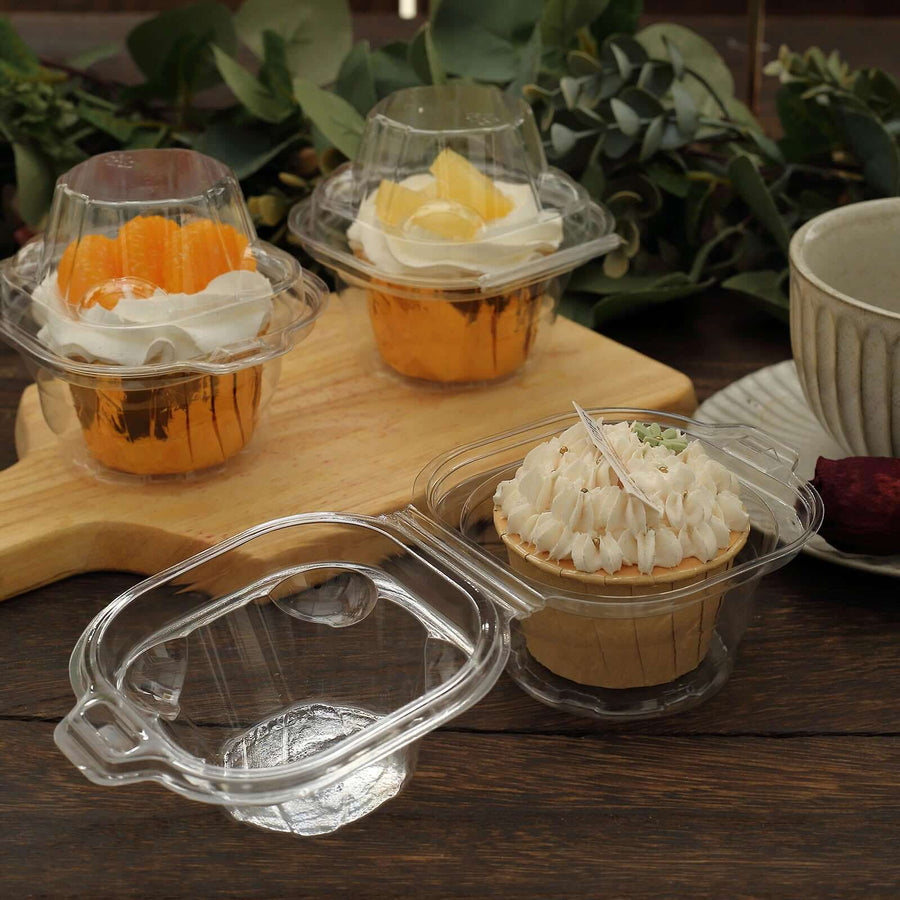 Clear dessert cups with various treats on a wooden surface.