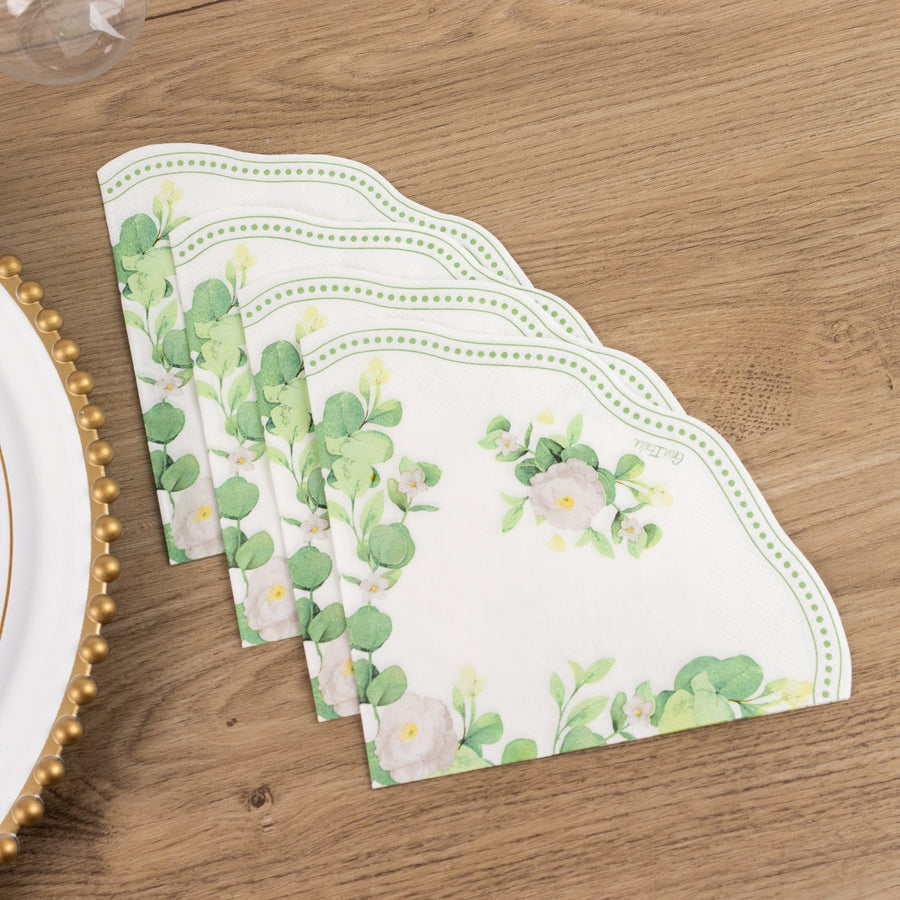 Decorative floral paper napkins stacked on a wooden table.