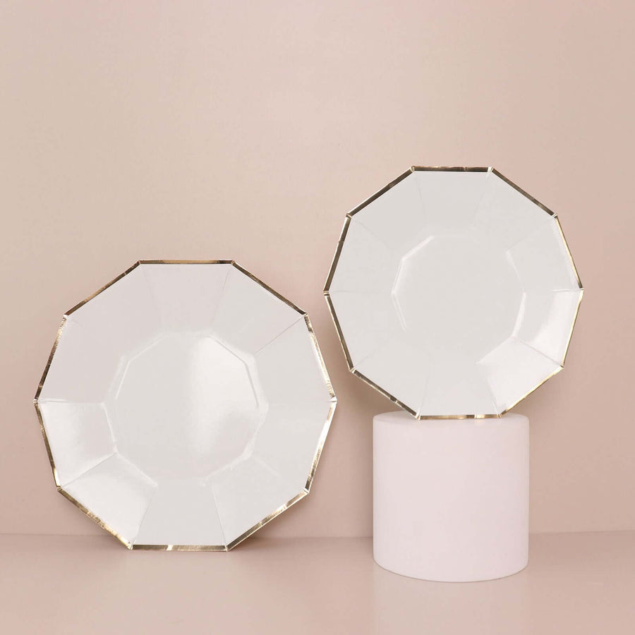 Elegant white plates with gold trim, displayed on a pedestal.