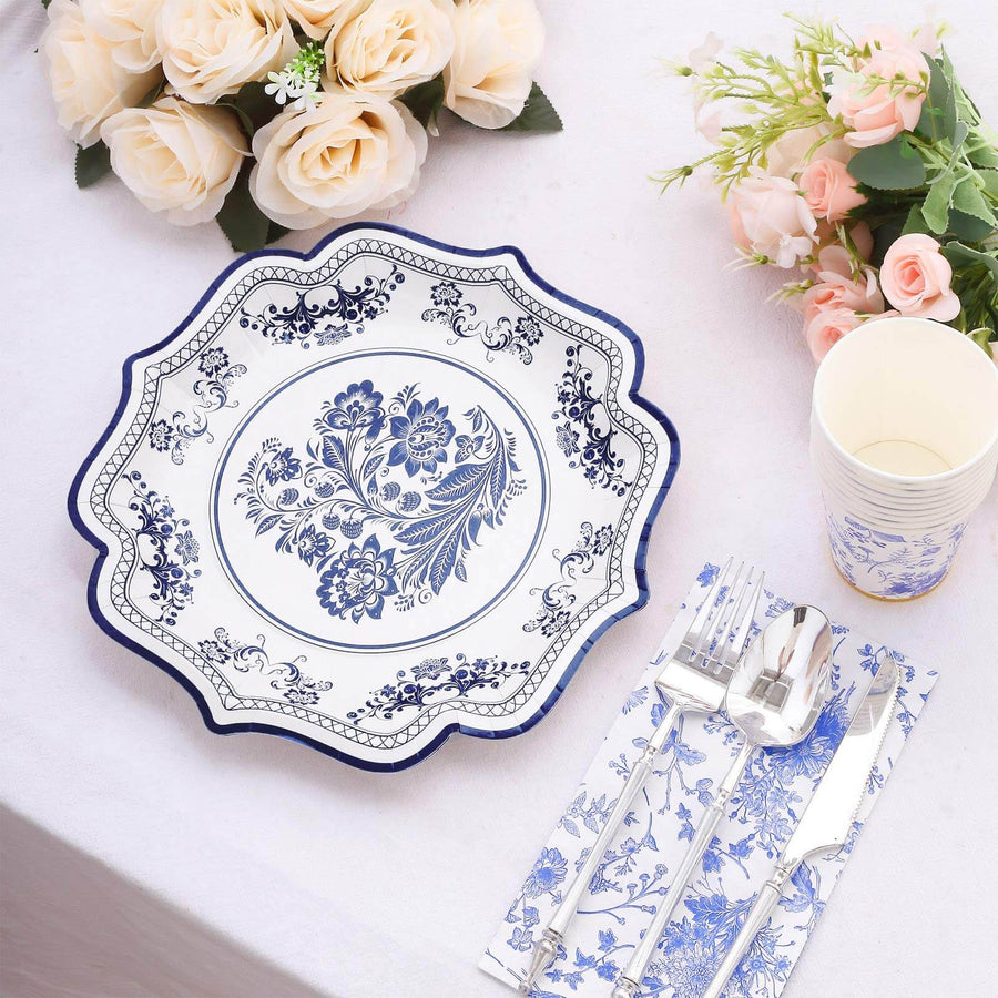 Decorative floral dinner plate with cutlery and napkin on a table setting.